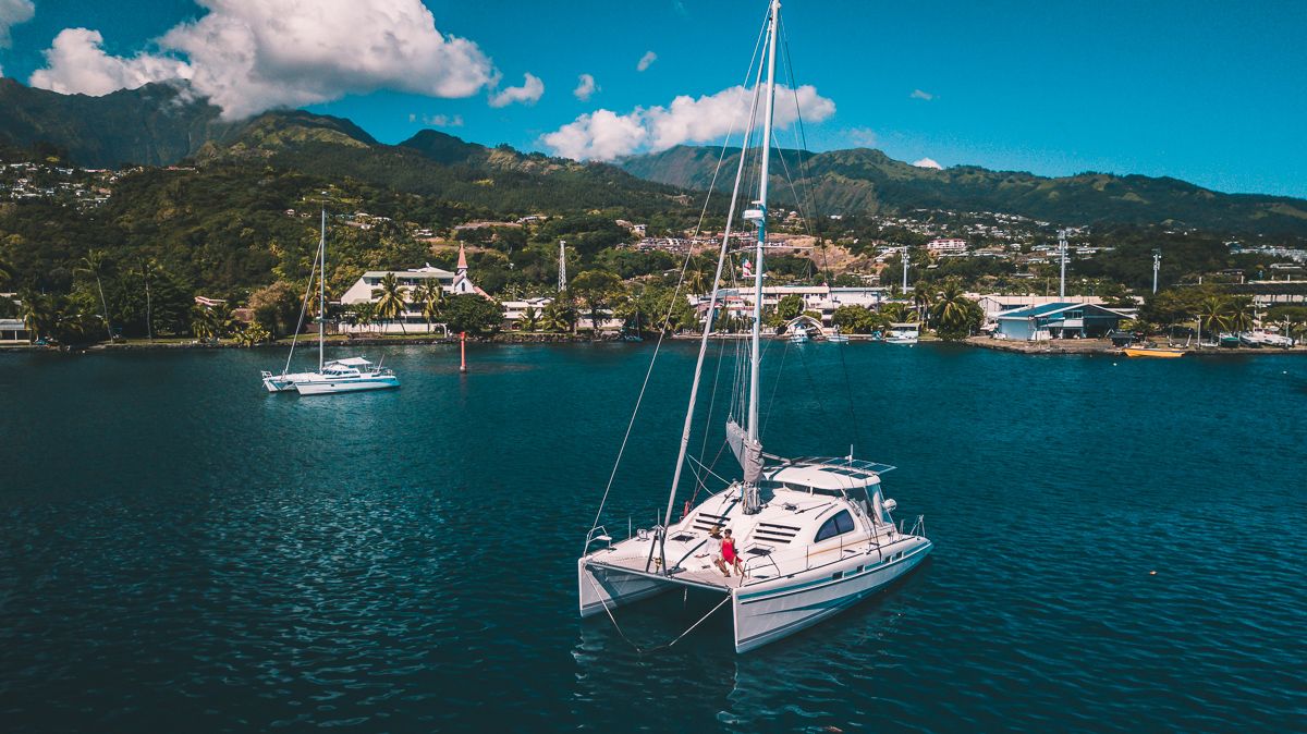 s/v curiosity at anchor in Tahiti with Jason and Nikki Wynn on deck