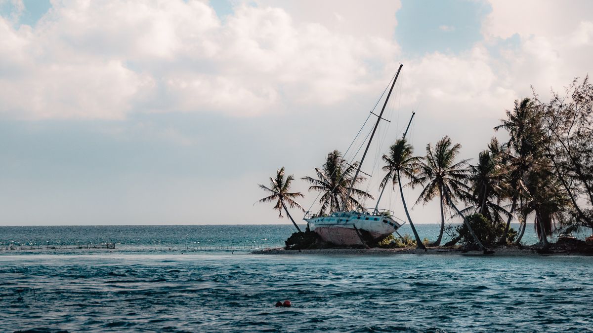 sailboat washed up on reef in tuamotu