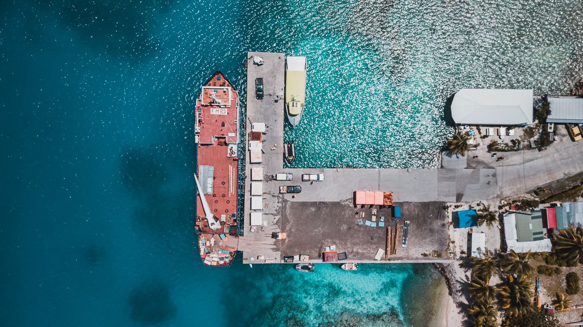 drone view of rangiroa atoll in tuamotu and a supply ship at harbor