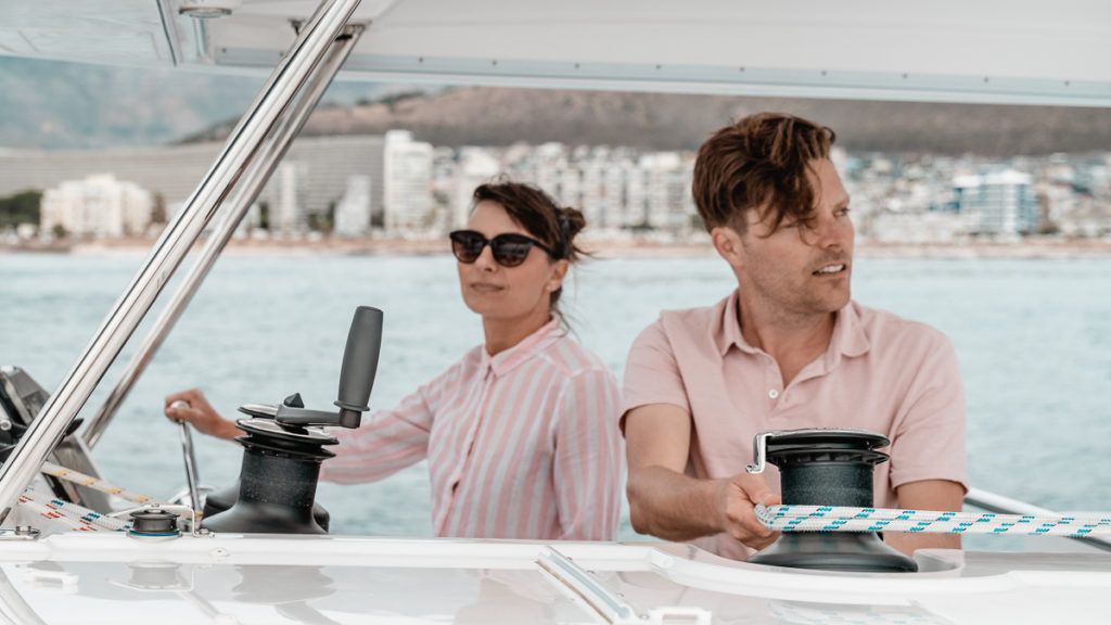 jason and nikki wynn at the helm of a leopard catamaran in south africa